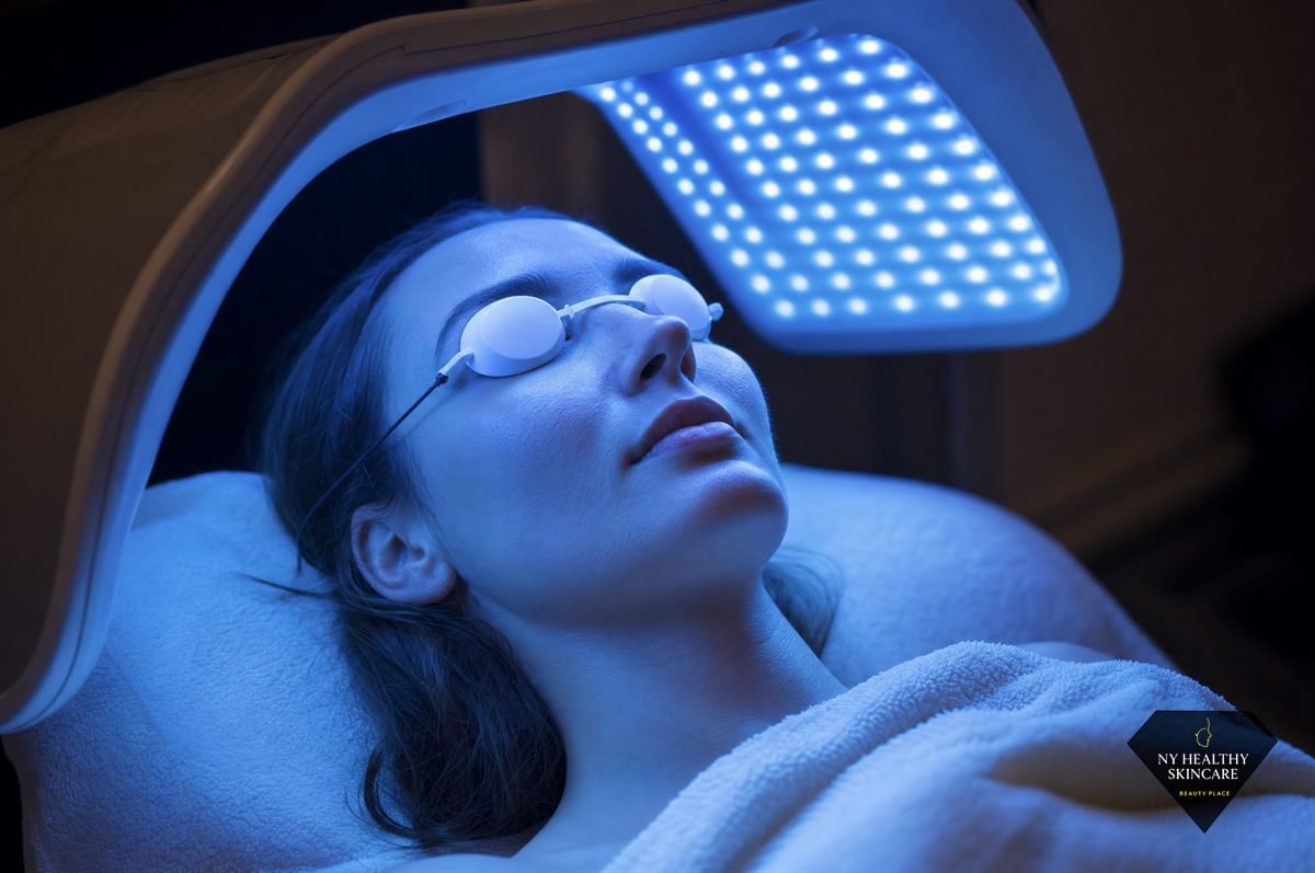 Blue LED light therapy used to calm active breakouts during an acne facial in Midtown Manhattan